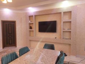 a conference room with a table and a flat screen tv at SUNRISE Guest House in İsmayıllı