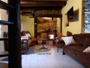 a living room with a couch and a fireplace at Casa do Pátio e Casa da Serra in Castanheira de Pêra