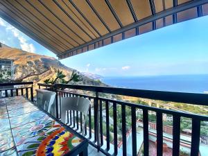 a balcony with a view of the ocean at Blue Marine Taormina in Taormina