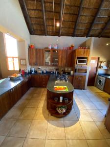 a large kitchen with a island in the middle at Luna rossa 19 Zebula golf course and spa resort in Mabula