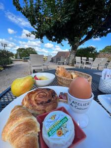 a plate of pastries and eggs on a table at Hôtel Les Vieilles Tours Rocamadour in Rocamadour