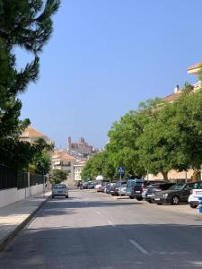 a street with cars parked in a parking lot at Agradable Adosado 3 plantas Altea in Altea