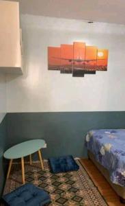 a room with a bed and a table and a stool at Delightful House in the Heart of Legazpi, Albay. in Legazpi