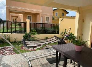 a porch with a hammock and a house at Delightful House in the Heart of Legazpi, Albay. in Legazpi