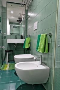 a bathroom with a sink and a toilet at Cave Bianche Apartments in Favignana