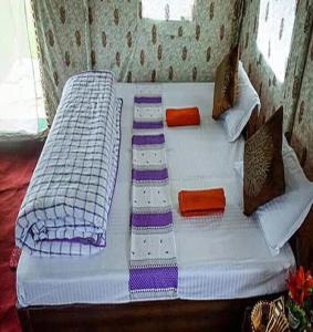 a large white bed with pillows at Camping Huts at Lord Shiva Camps in Sari