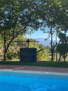 a swimming pool with a view of the mountains at Quinta da Mal-disposta, cabin lodge Countryhouse in Resende