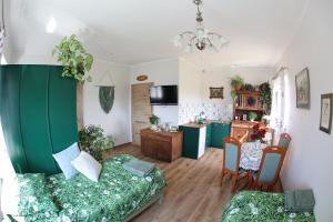 a living room with a couch and a table at Zielona Przystań in Boruja