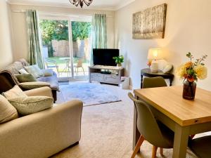a living room with a couch and a table at Cosy Bungalow Near Open Countryside in Felixstowe