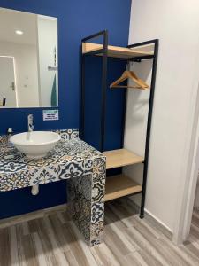 a bathroom with a sink and a mirror at Capital Hotel Saltillo in Saltillo