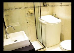 y baño con ducha, lavabo y aseo. en Copacabana Vista Mar Studio, en Río de Janeiro