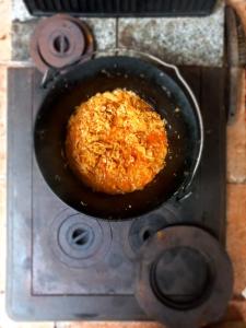 a food being cooked in a pan on a stove at SOHO Lodge Rasnov in Râşnov +40 photos