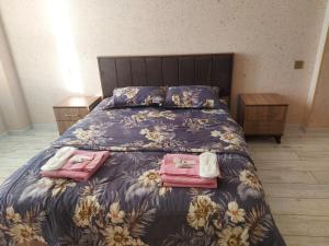 a bedroom with a bed with two bags on it at SUNRISE Guest House in İsmayıllı