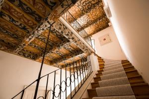 a staircase in a house with a tile ceiling at Hotel Nerudova 211 in Prague