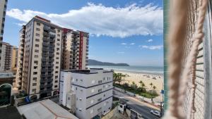 a view of the beach from the balcony of a building at Apartamento kit Praia Grande na Guilhermina Frente Mar in Praia Grande