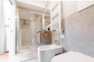 a white bathroom with a toilet and a shower at Realkasa Amendola Apartment in Bologna