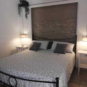 a bedroom with a large bed with two night stands at Prima Stella Tourist Rooms in Minturno