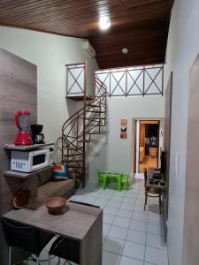 a living room with a spiral staircase in a house at FLAT NA FAZENDA MONTE CASTELO GRAVATÁ - Pe in Gravatá