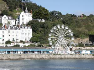 una noria delante de un gran edificio blanco en Amlwch, en Llandudno