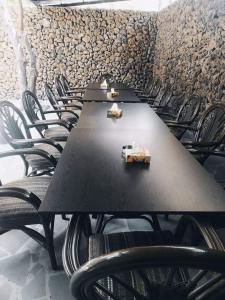 a long black table and chairs in a room at Zangezur Hotel in Goris