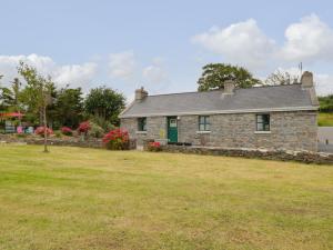 an old stone house with a large yard at Toms Cottage in Westport
