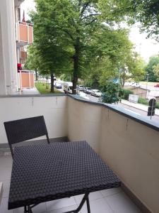 a bench on a balcony with a view of a street at gemütliche kleine Ferienwohnung in Chemnitz
