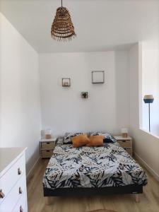 a bedroom with a bed in a white room at Studio entre lac de Monteynard et Gresse-en-Vercors in Monestier-de-Clermont