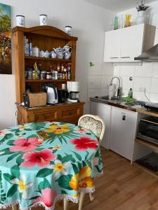 a kitchen with a table with a flower pattern on it at Mitten in Düsseldorf in Düsseldorf