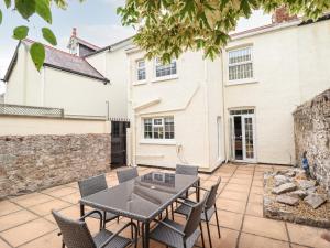 a patio with a table and chairs and a building at Owen Villa in Llandudno