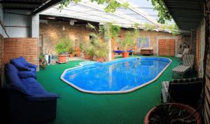 a large swimming pool in the middle of a yard at Couleurs du Daumail in Saint-Priest-sous-Aixe