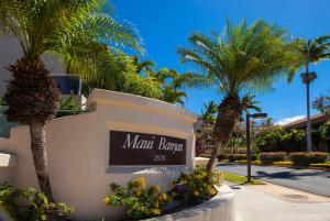 a sign for a main entrance to a hotel with palm trees at Maui Banyan H311 1BD 2BA 3 min walk to the beach in the Heart of South Kihei! in Wailea