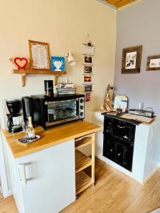 a kitchen with a counter top with a microwave at ,,Björklunda" cozy apartment in swedish lapland in Lycksele