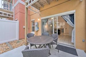 a patio with a table and chairs on a patio at Family-Friendly Lake Berkeley Resorts Home! in Kissimmee
