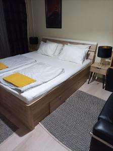 a bedroom with a large bed with a wooden frame at Panorama apartment near Szeged Plaza in Szeged
