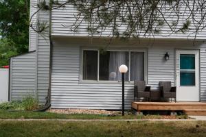 a house with a bench in front of a window at Idlewild Pines Retreat in Rapid City