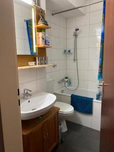 a bathroom with a sink and a toilet and a shower at Mitten in Düsseldorf in Düsseldorf