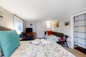 a living room with a large bed and a couch at Beach Rose Guest Studio in Nauset Heights
