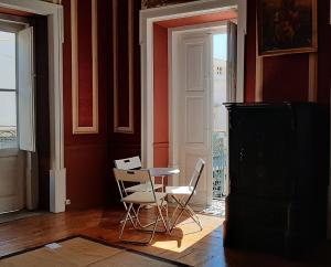 a dining room with two chairs and a table at A Casa do Tenente in Faro