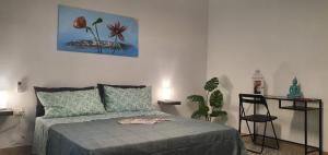 a bedroom with a bed and a painting on the wall at Chafbius Saint Remy in Cagliari