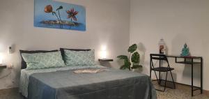 a bedroom with a bed and a chair in it at Chafbius Saint Remy in Cagliari