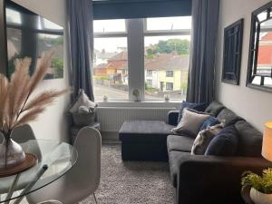 a living room with a couch and a glass table at The Retreats 2 Kenfig Hill Pet Friendly 2 Bedroom Flat with King Size bed twin beds and sofa bed sleeps up to 5 people in Kenfig Hill