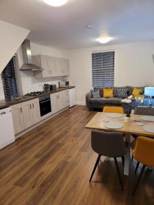 a kitchen and living room with a table and a couch at Waterdale Lodge in Galway