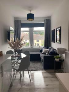 a living room with a couch and a table at The Retreats 2 Kenfig Hill Pet Friendly 2 Bedroom Flat with King Size bed twin beds and sofa bed sleeps up to 5 people in Kenfig Hill