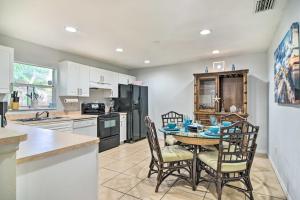 a kitchen with a table and chairs in a kitchen at St Pete Bungalow Less Than 2 Mi to Beach and Downtown! in St Petersburg