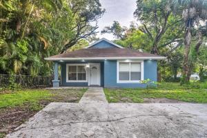 a blue house with a driveway in front of it at St Pete Bungalow Less Than 2 Mi to Beach and Downtown! in St Petersburg