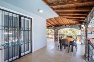 a dining room with a table and chairs on a balcony at Villa Erya 2 in Fethiye