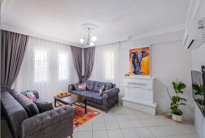 a living room with two couches and a fireplace at Villa Erya 2 in Fethiye