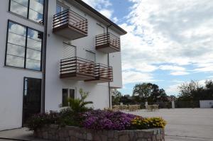 a white building with balconies and flowers at Elaia Garden Hotel in Sperlonga