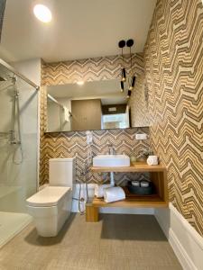 a bathroom with a toilet and a sink at The Tailor's Garden in Santiago de Compostela