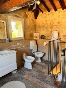 a bathroom with two toilets and a sink at Chianti chic in Gaiole in Chianti +12 photos